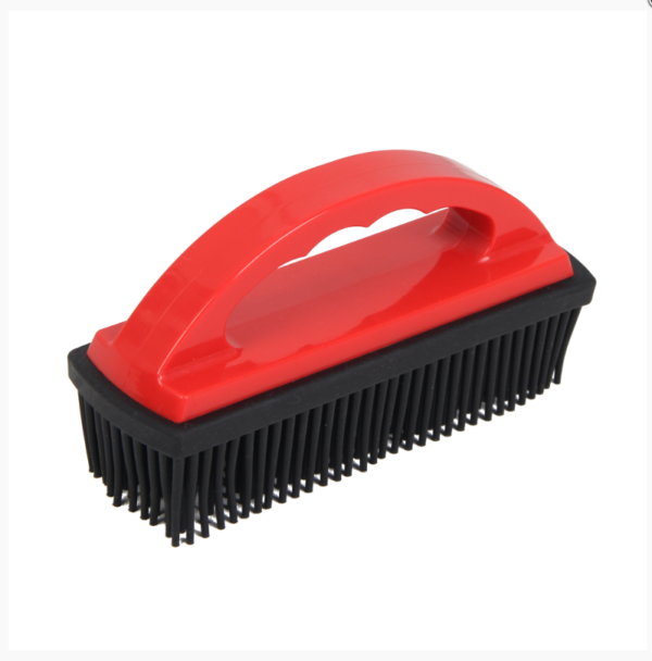 Red and black rubber hair and lint removal brush